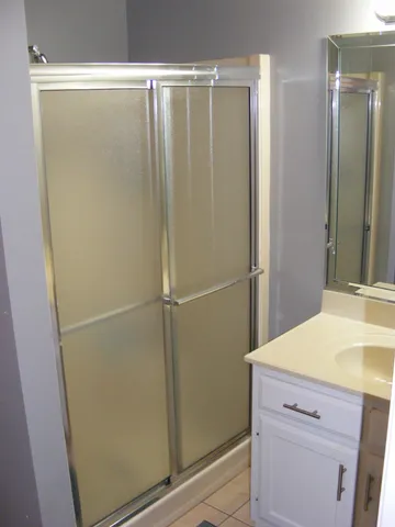 a bathroom with a shower and a sink