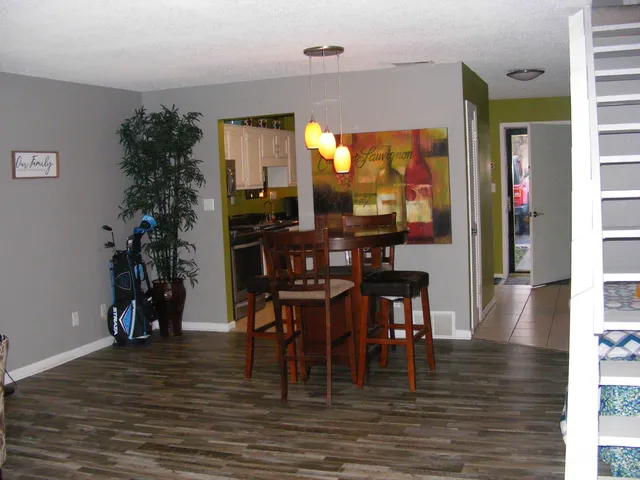 a view of a dining room with furniture and wooden floor