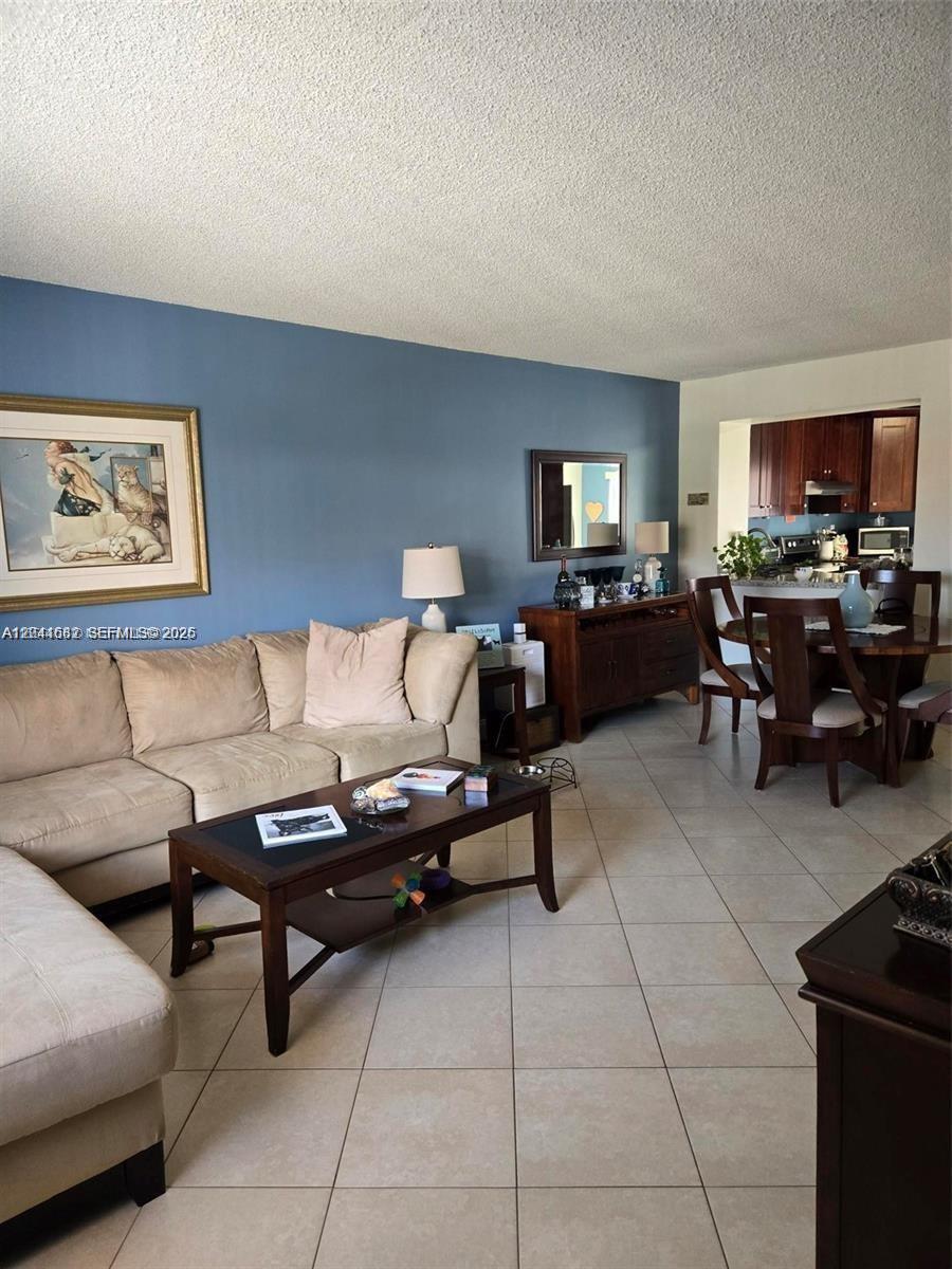 2174 West 60th Street, Unit 17205 Hialeah, FL 33016 - Photo 2 of 11 a living room with furniture and a flat screen tv