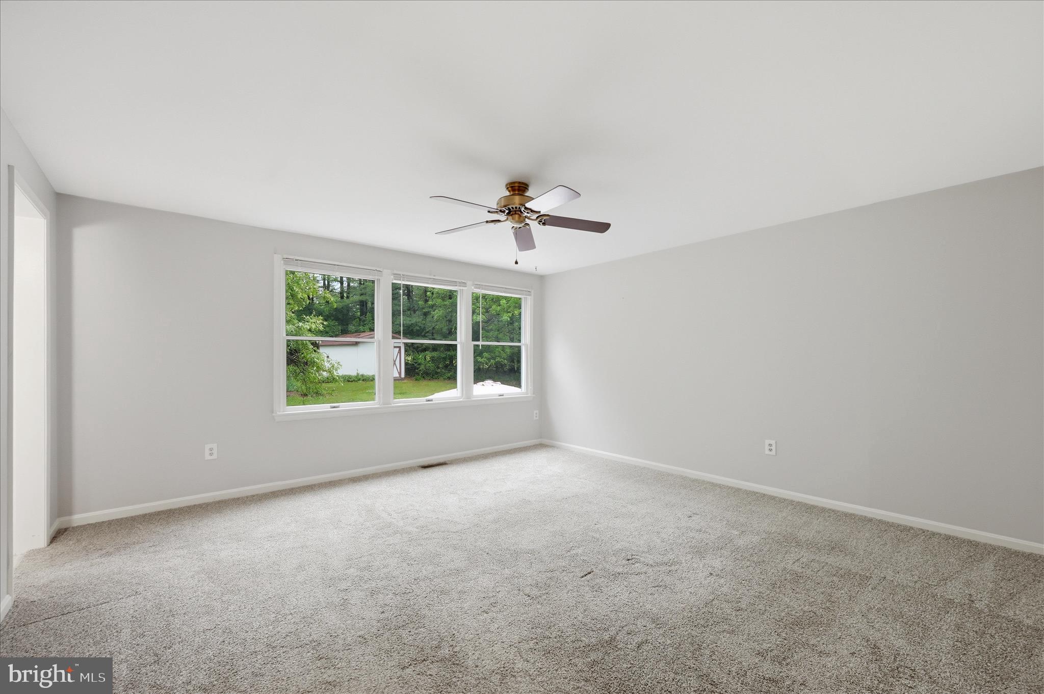 244 High Banks Road Stephenson, VA 22656 - Photo 21 of 45 a view of a livingroom with a ceiling fan and window