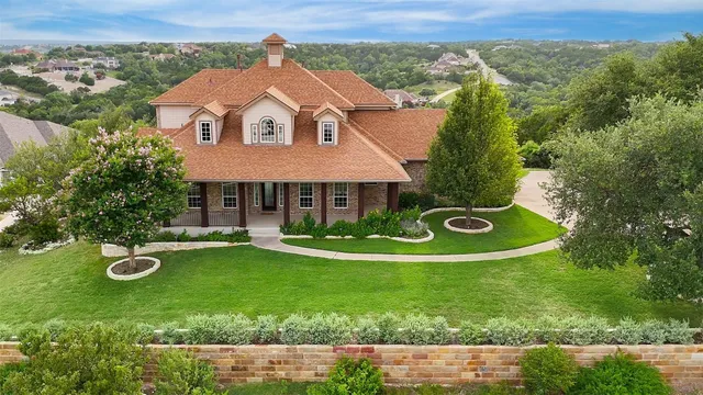 an aerial view of a house with garden space and street view