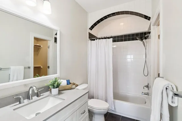 a view of a hallway with wooden floor and windows