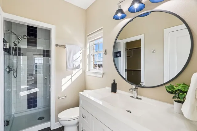 a bathroom with a sink a toilet and a mirror