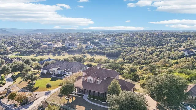 an aerial view of residential house with outdoor space and parking