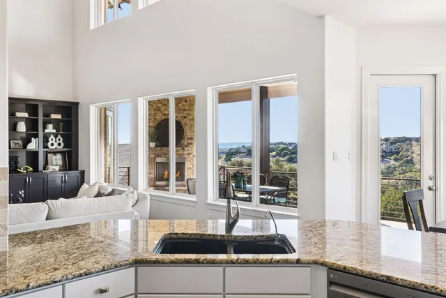 a kitchen with granite countertop a sink and a large window