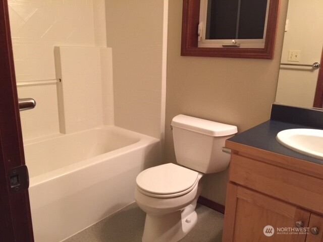 1126 Northwest 56th Street Seattle, WA 98107 - Photo 6 of 8 a white toilet sitting next to a bathroom sink