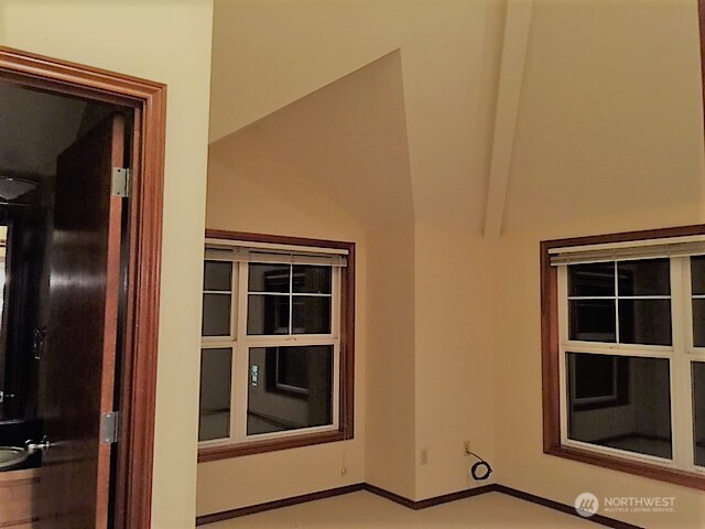 1126 Northwest 56th Street Seattle, WA 98107 - Photo 8 of 8 a view of an empty room with wooden floor and windows