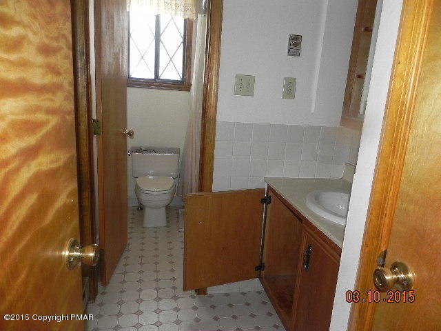 4146 Blueberry Hill Road Bushkill, PA 18324 - Photo 3 of 14 a bathroom with a sink and a toilet