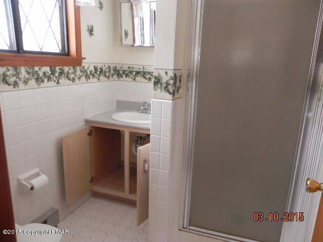 4146 Blueberry Hill Road Bushkill, PA 18324 - Photo 8 of 14 a bathroom with a sink and toilet