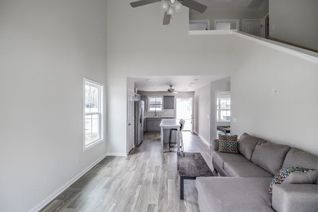 a living room with furniture and a wooden floor