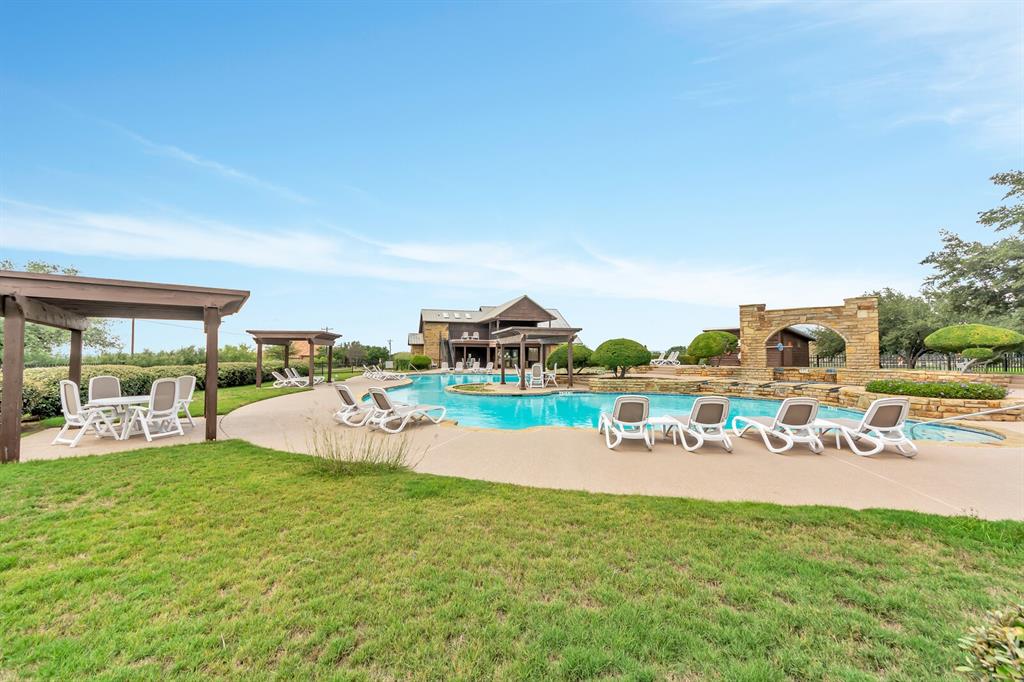 Tbd Turnberry Loop Graford, TX 76449 - Photo 14 of 15 a view of a swimming pool with outdoor seating and a garden