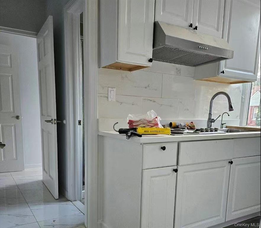 144-18 Negundo Avenue Queens, NY 11355 - Photo 2 of 7 a sink with white cabinets