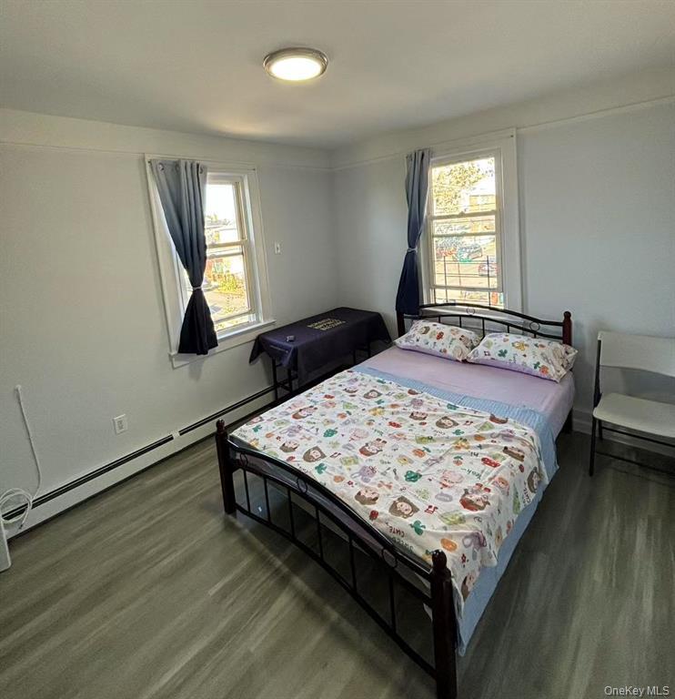 144-18 Negundo Avenue Queens, NY 11355 - Photo 4 of 7 a bed sitting in a bedroom next to a window