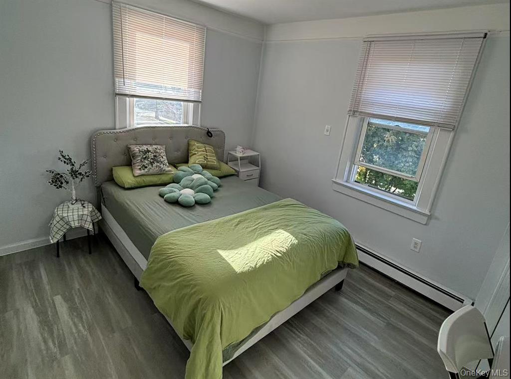 144-18 Negundo Avenue Queens, NY 11355 - Photo 5 of 7 a bedroom with a bed and windows