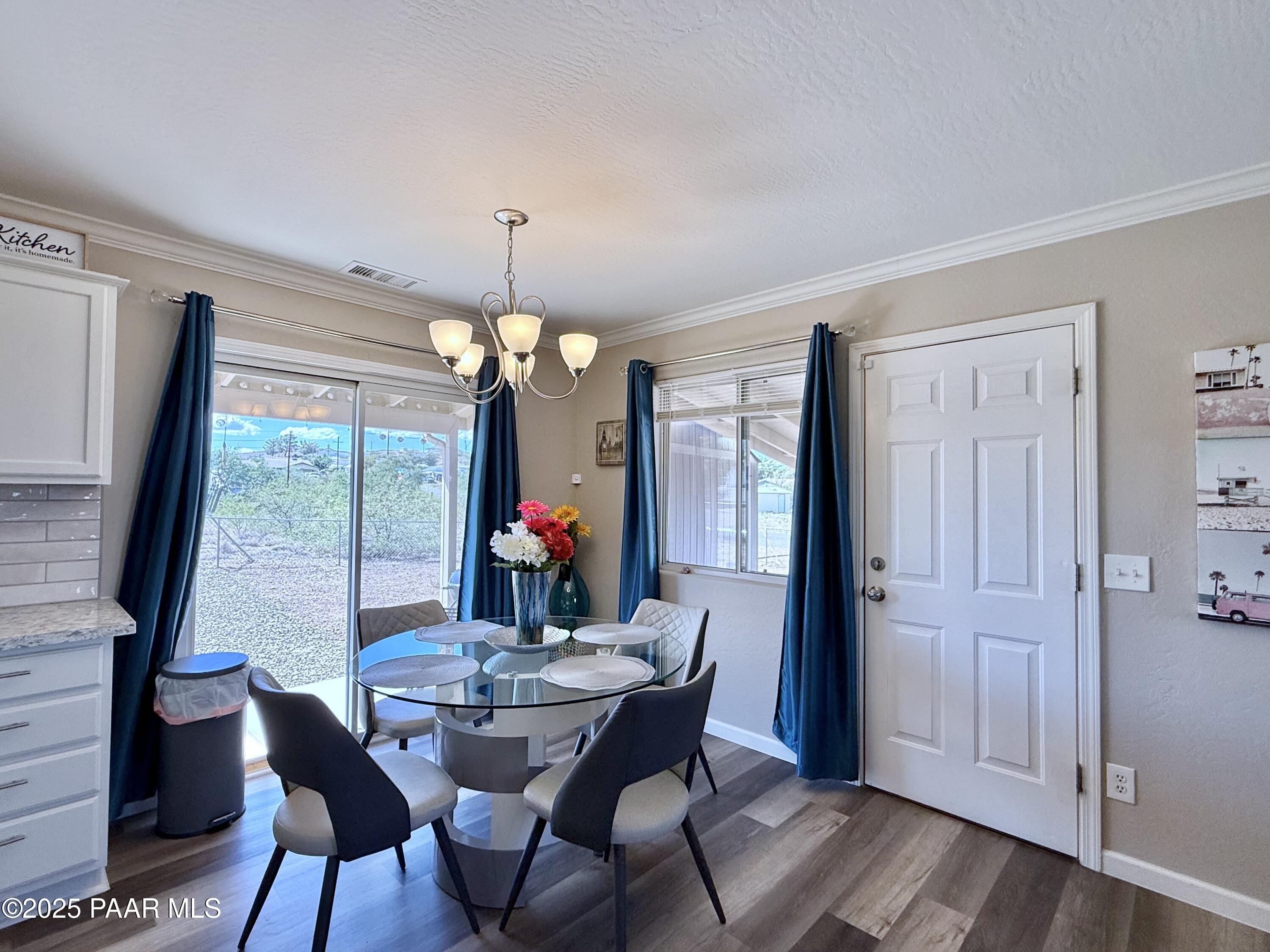 20233 East Sunset Lane Mayer, AZ 86333 - Photo 11 of 42 a view of a dining room with furniture window and wooden floor