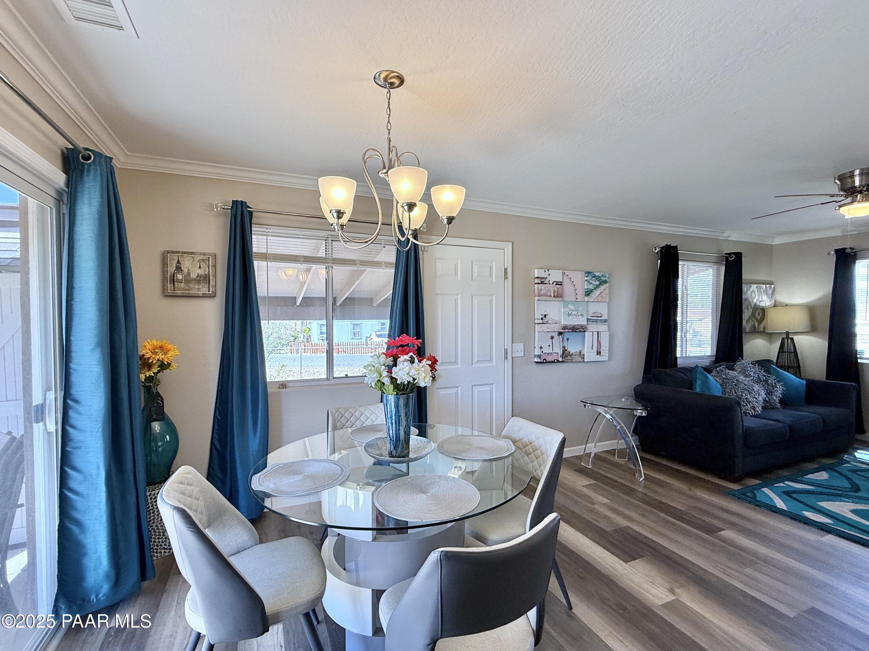 20233 East Sunset Lane Mayer, AZ 86333 - Photo 12 of 42 a dining room with furniture a chandelier and window