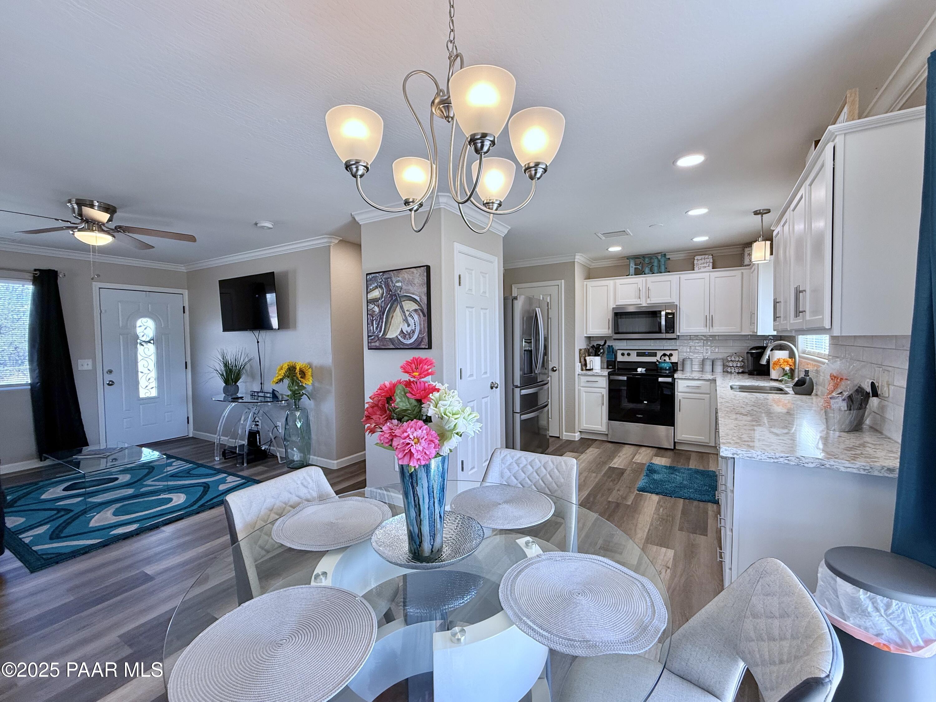20233 East Sunset Lane Mayer, AZ 86333 - Photo 13 of 42 a kitchen view with dining table and stainless steel appliances