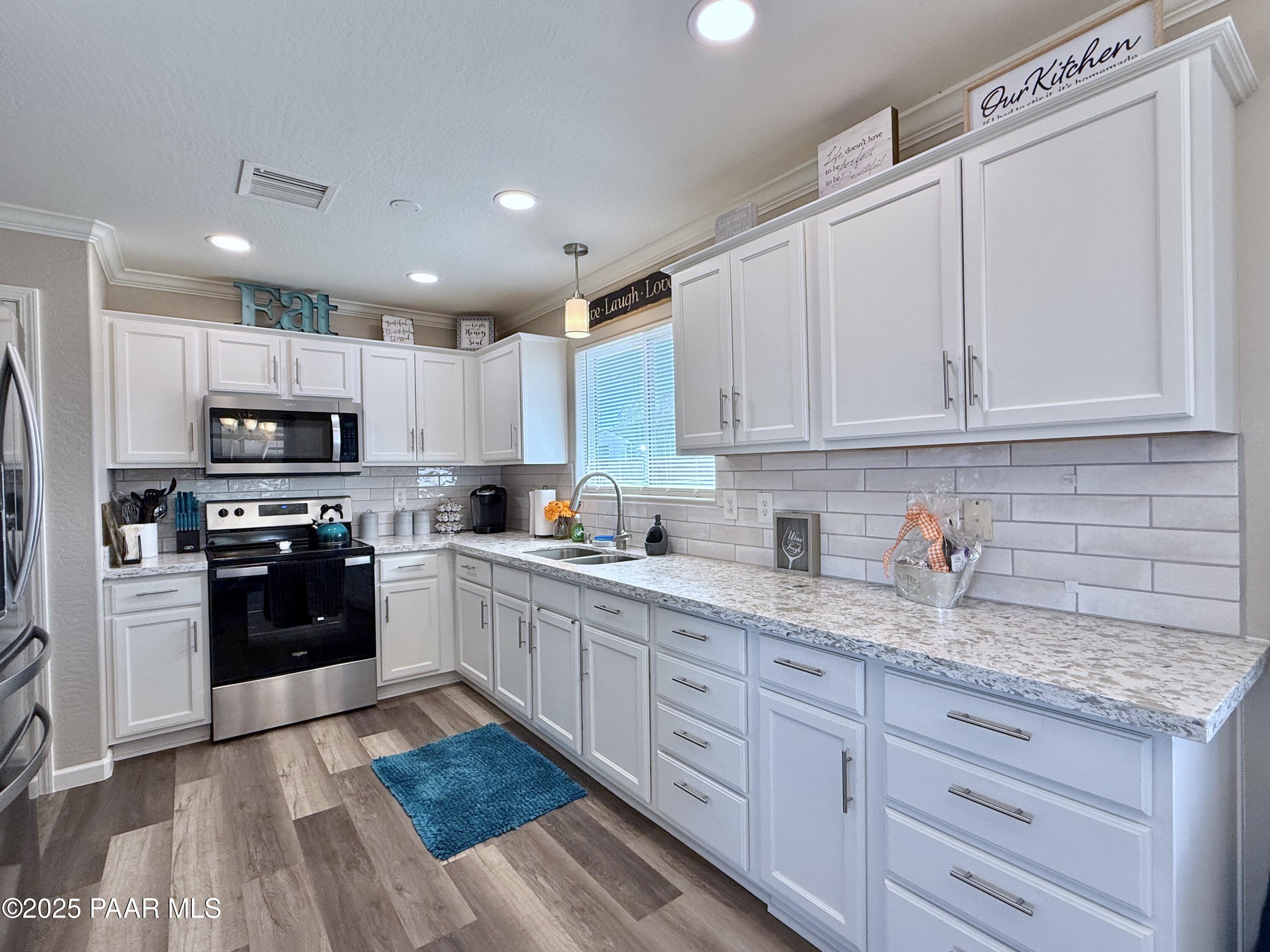 20233 East Sunset Lane Mayer, AZ 86333 - Photo 15 of 42 a kitchen with granite countertop white cabinets and stainless steel appliances
