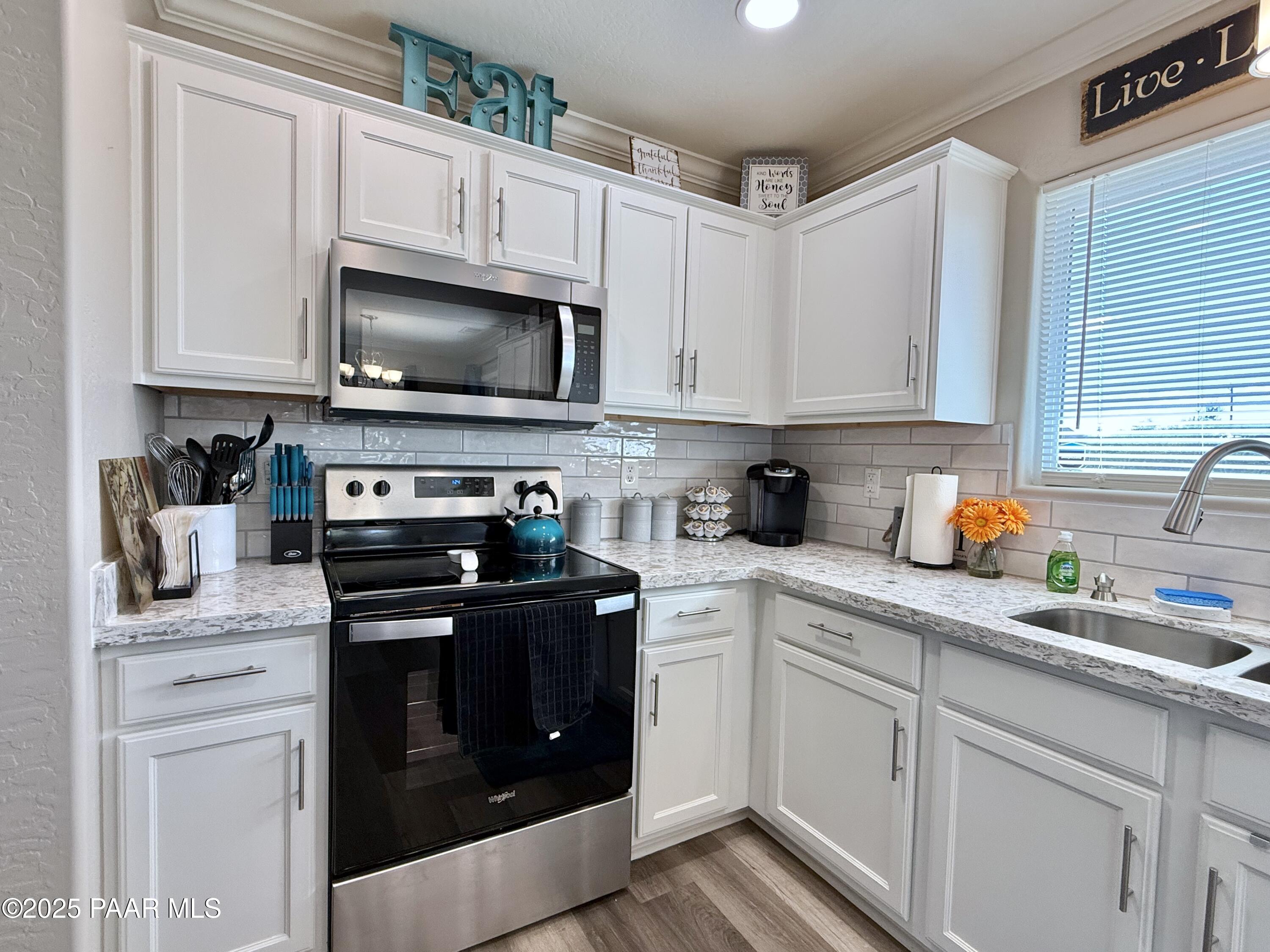 20233 East Sunset Lane Mayer, AZ 86333 - Photo 16 of 42 a kitchen with stainless steel appliances granite countertop grey cabinets a stove a sink and dishwasher