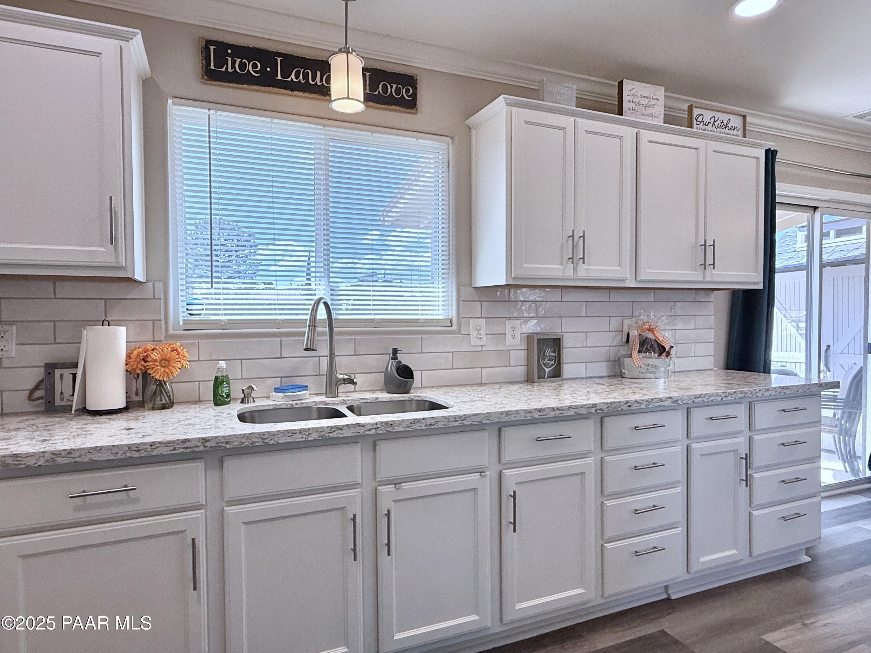 20233 East Sunset Lane Mayer, AZ 86333 - Photo 18 of 42 a kitchen with white cabinets and white appliances