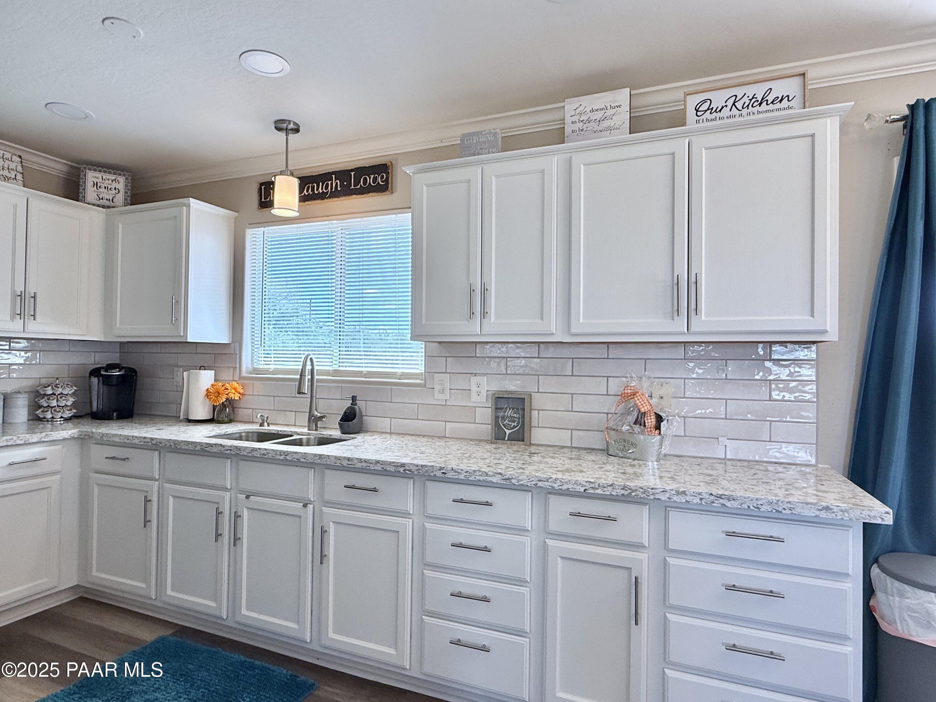 20233 East Sunset Lane Mayer, AZ 86333 - Photo 19 of 42 a kitchen with white cabinets and white appliances