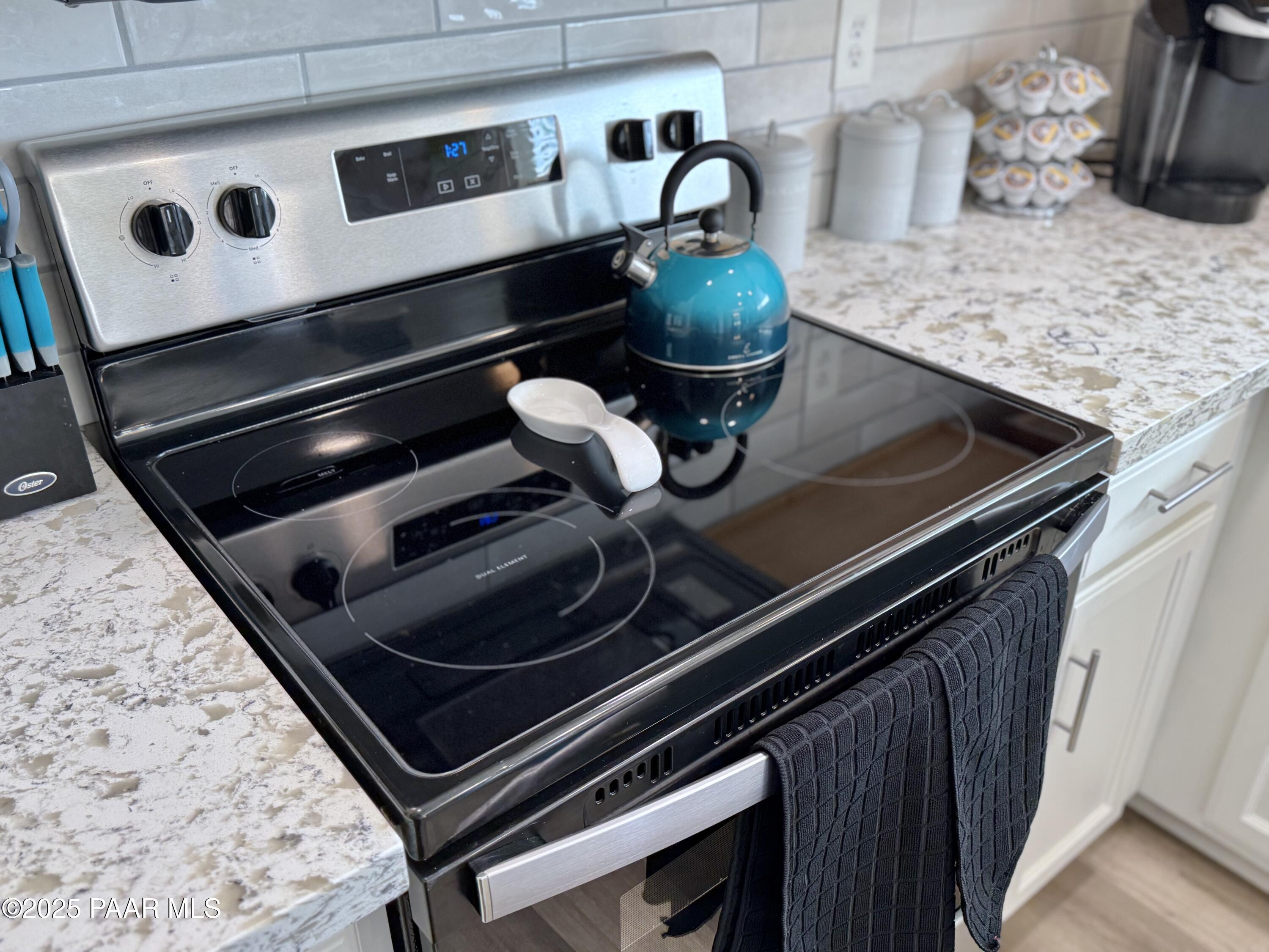 20233 East Sunset Lane Mayer, AZ 86333 - Photo 23 of 42 a stove top oven sitting inside of a kitchen