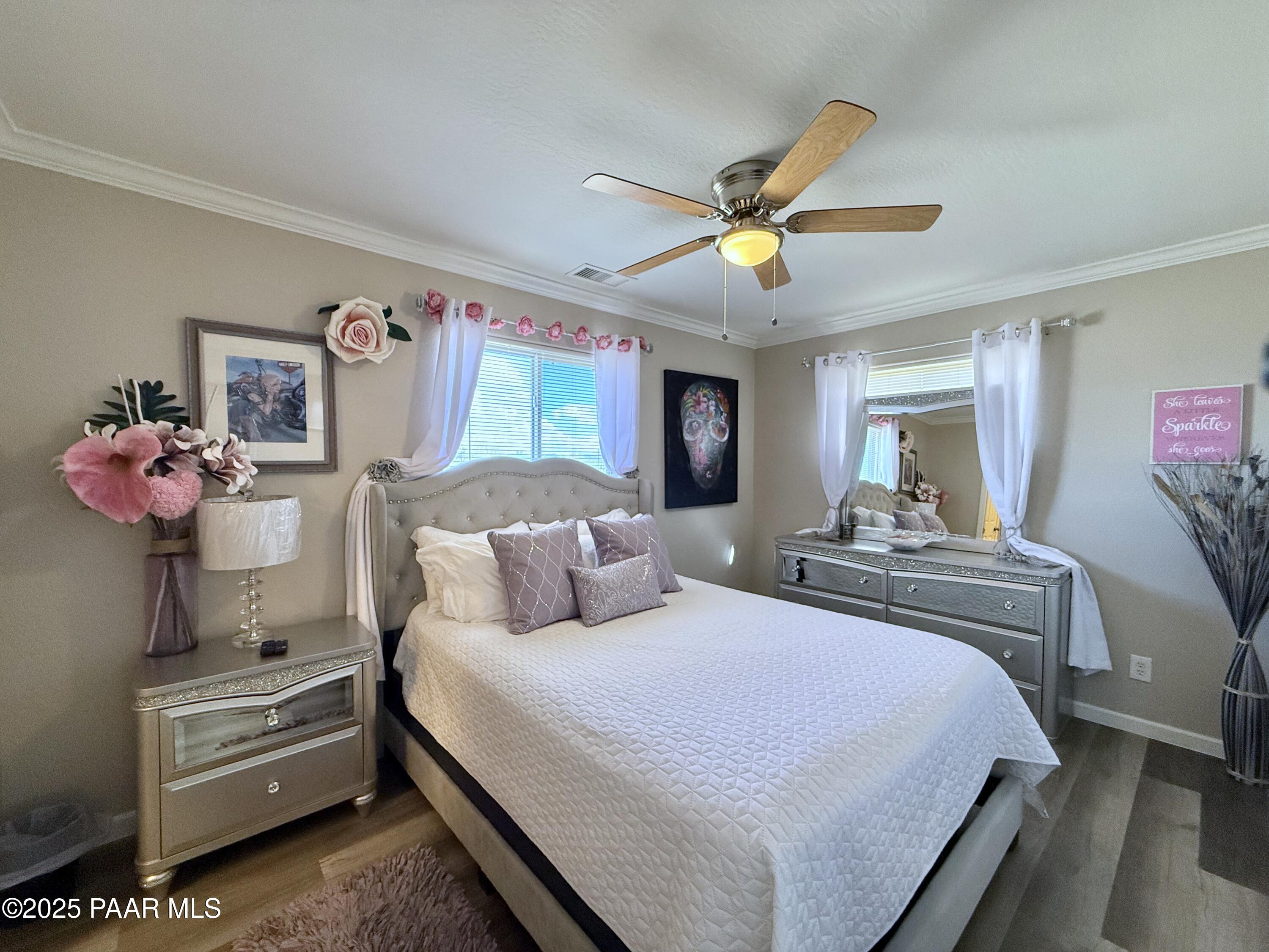 20233 East Sunset Lane Mayer, AZ 86333 - Photo 25 of 42 a bedroom with a bed and a chandelier