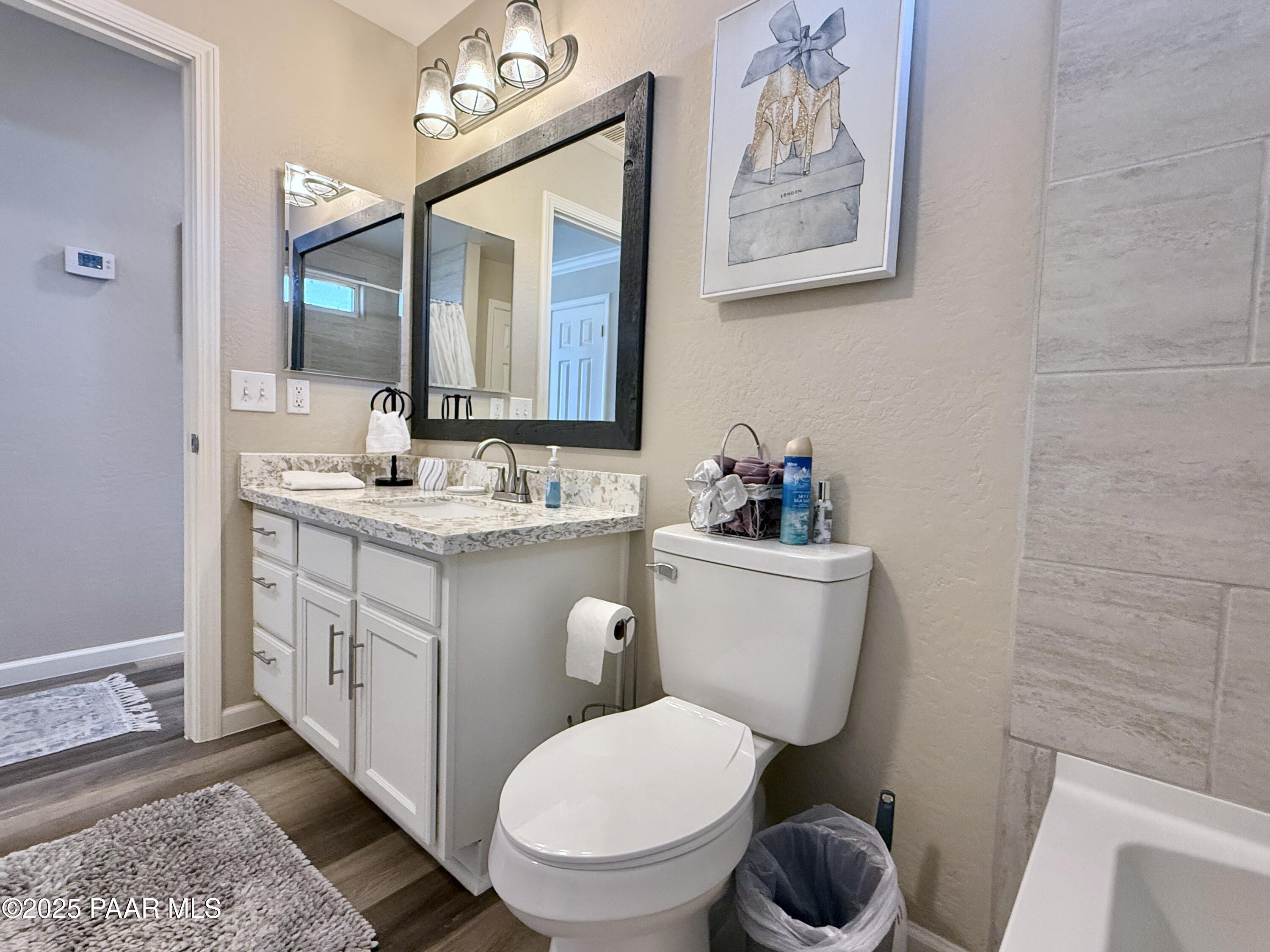 20233 East Sunset Lane Mayer, AZ 86333 - Photo 28 of 42 a bathroom with a toilet sink and mirror