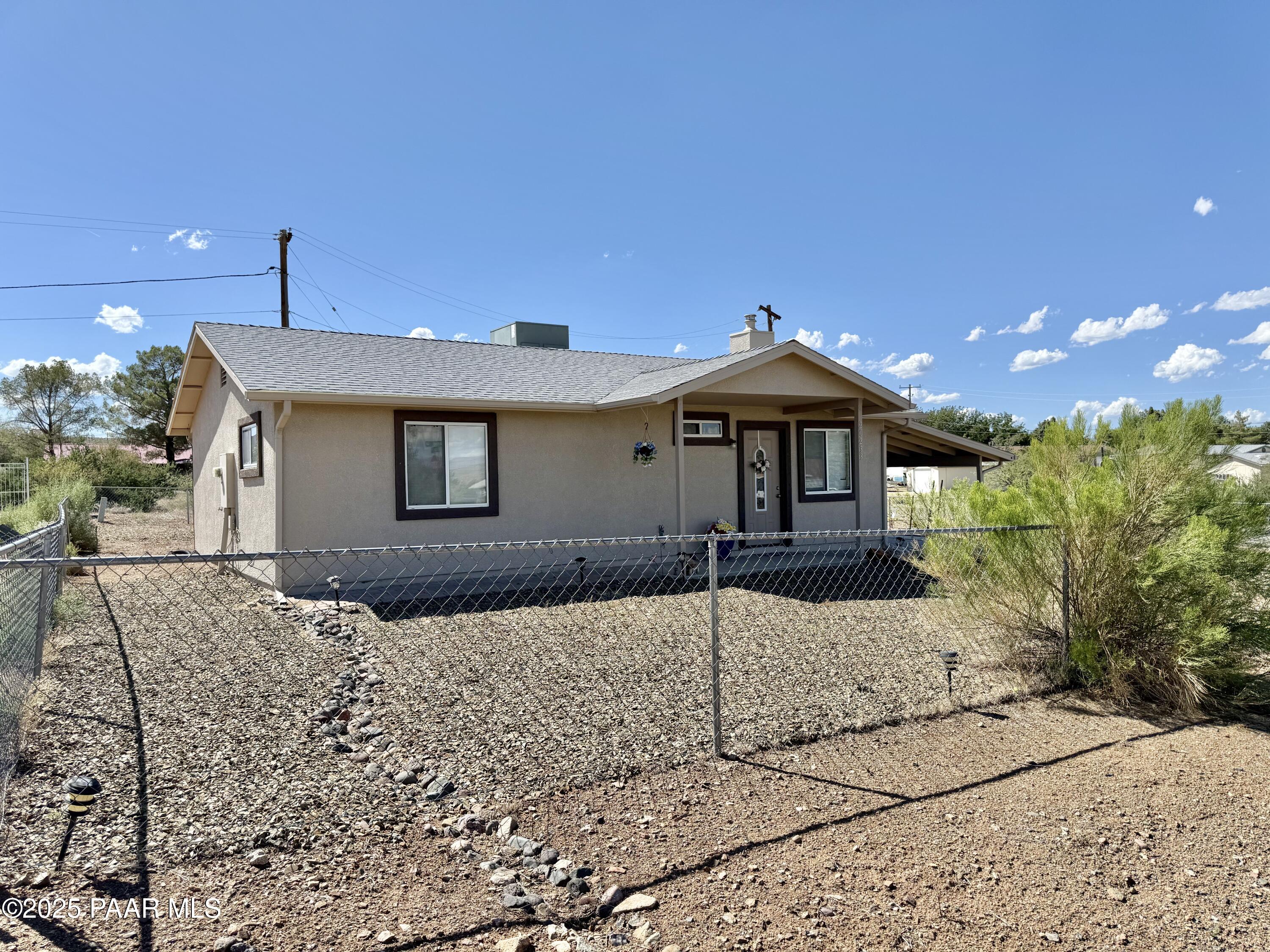 20233 East Sunset Lane Mayer, AZ 86333 - Photo 42 of 42 a front view of a house with a yard and garage