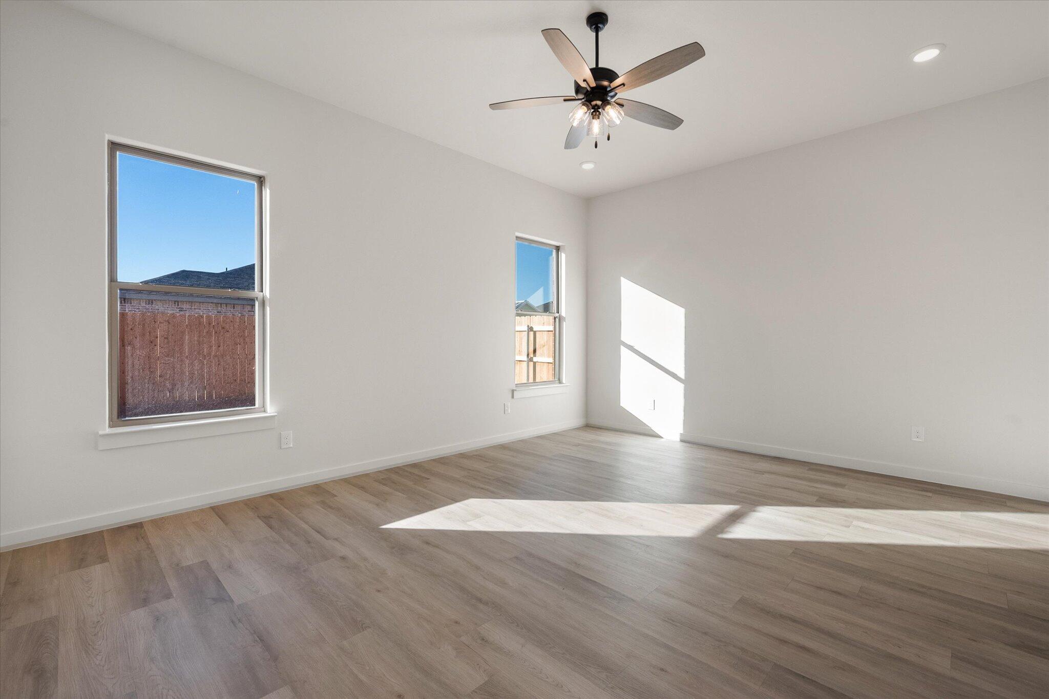 709 East 30th Street Wolfforth, TX 79382 - Photo 14 of 25 a view of an empty room with a window and wooden floor