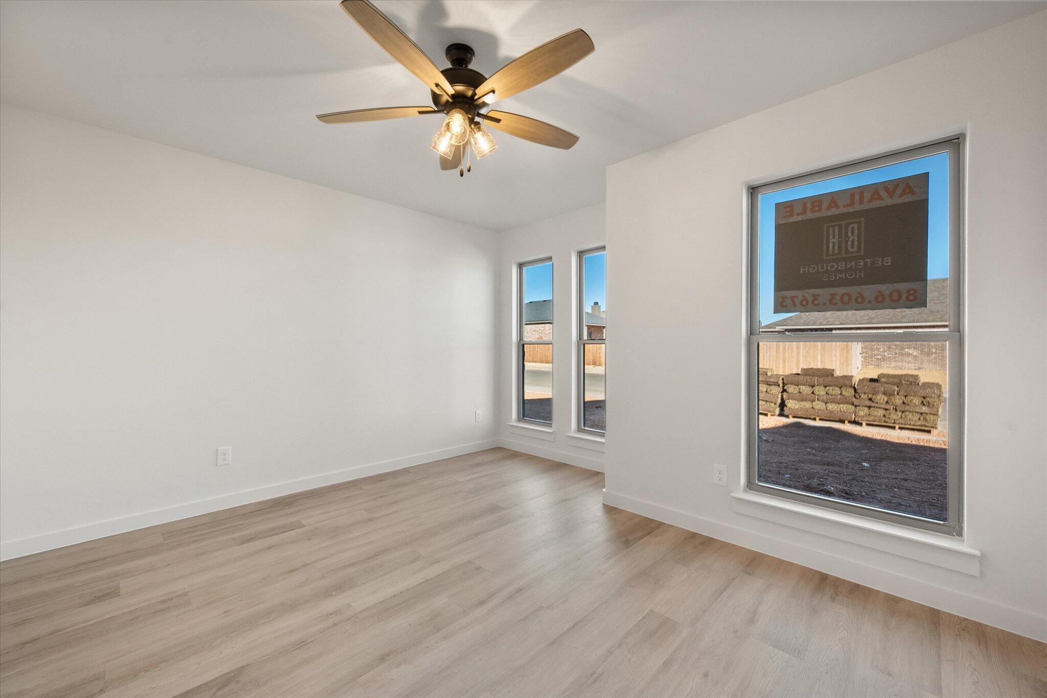 709 East 30th Street Wolfforth, TX 79382 - Photo 20 of 25 a view of an empty room with a window and wooden floor