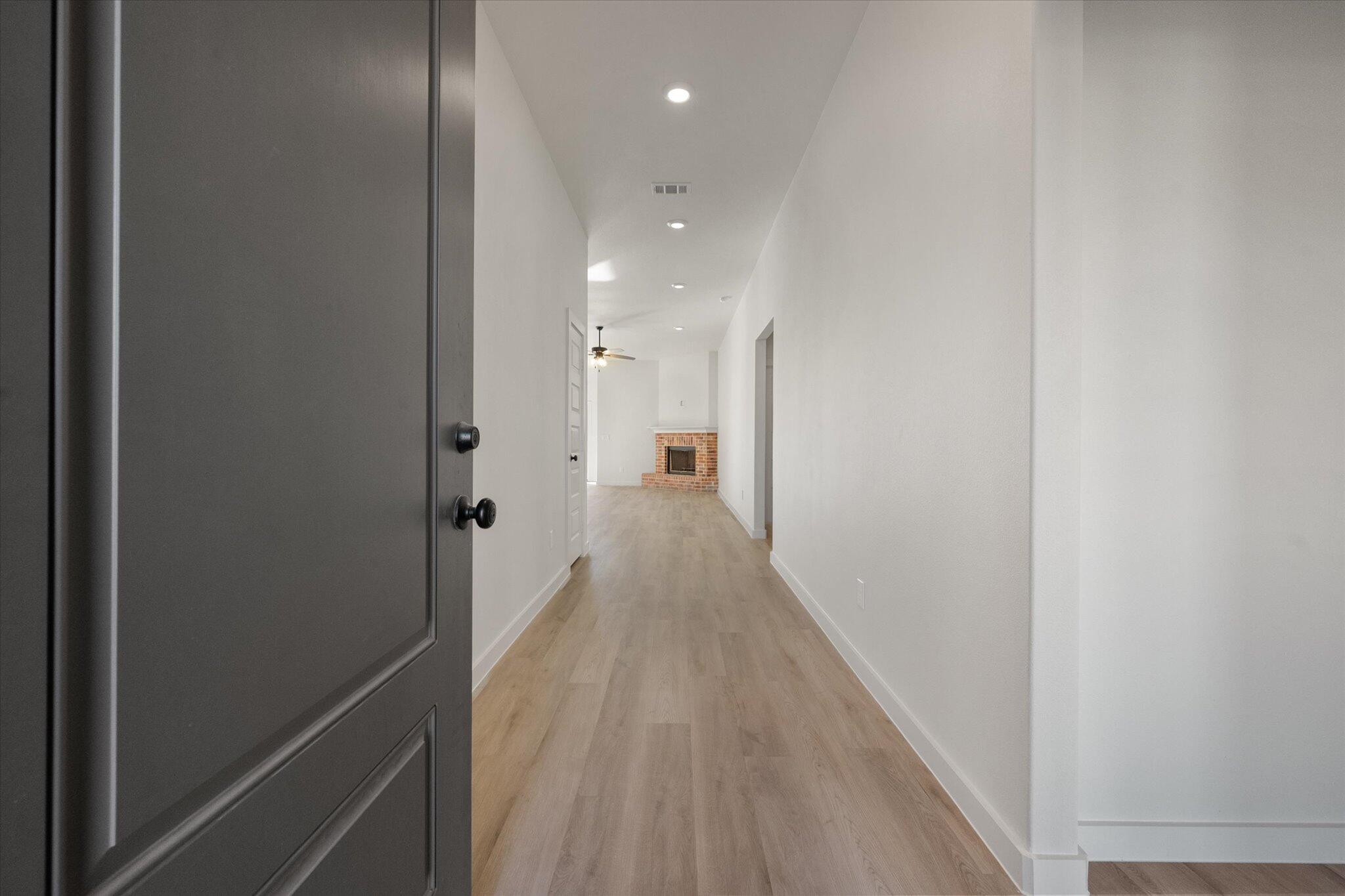 709 East 30th Street Wolfforth, TX 79382 - Photo 2 of 25 a view of a hallway with wooden floor