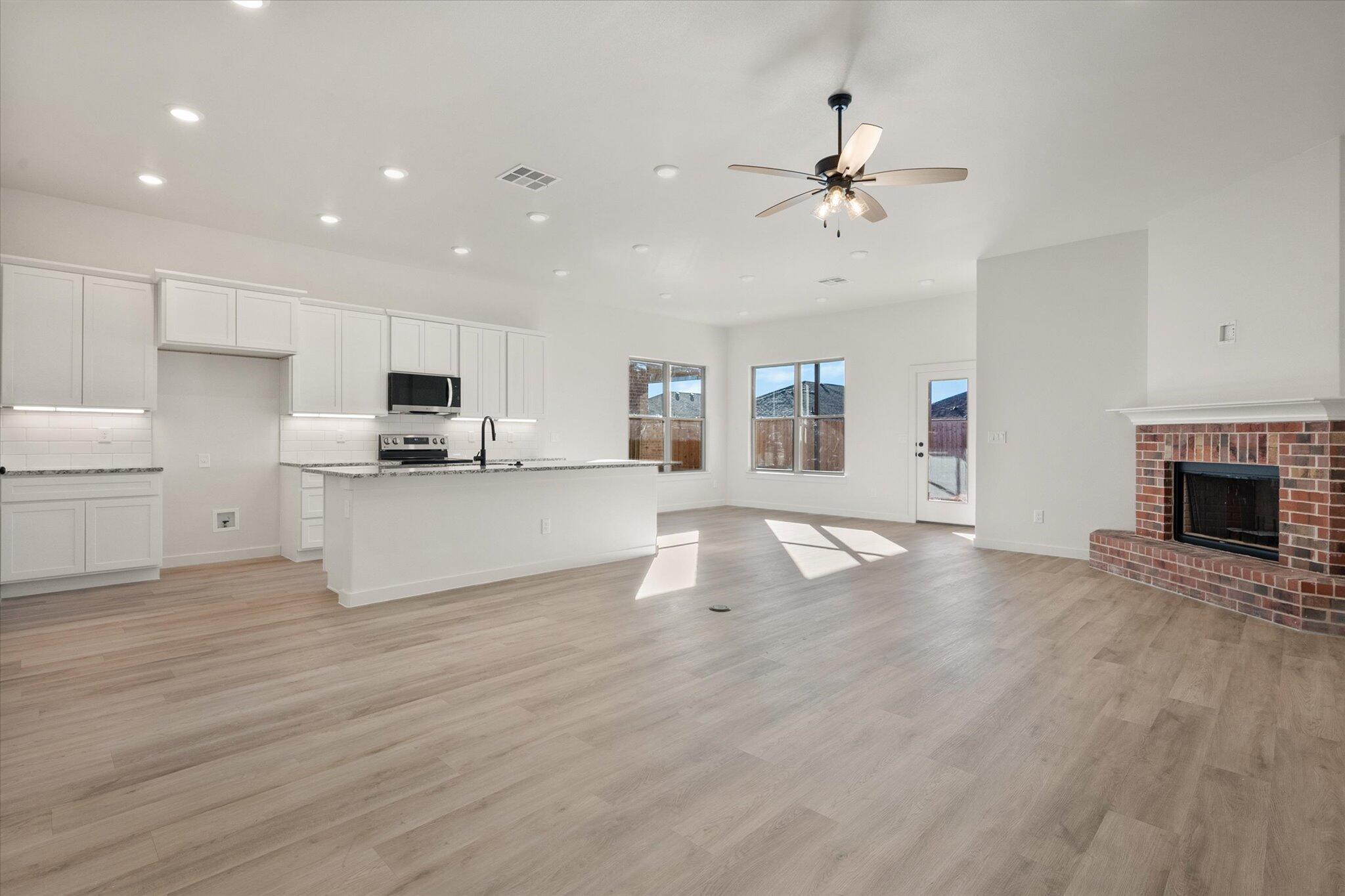 709 East 30th Street Wolfforth, TX 79382 - Photo 3 of 25 a view of a kitchen with a sink cabinets and wooden floor