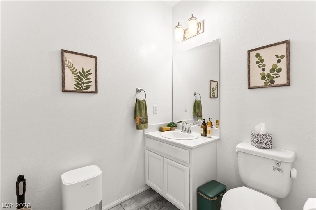 6435 Point Isabel Way Las Vegas, NV 89122 - Photo 18 of 57 A well-appointed powder room with crisp white walls and a functional vanity offers essential convenience.
