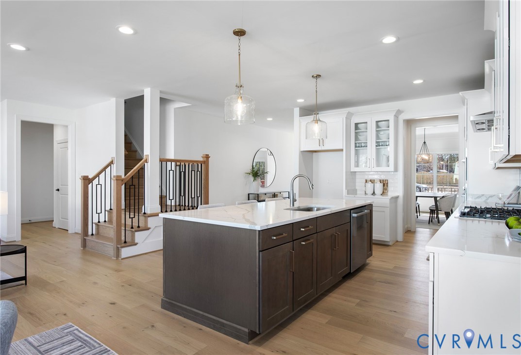 2831 Old Pump Road Henrico, VA 23233 - Photo 13 of 42 a kitchen with stainless steel appliances granite countertop a sink stove and wooden floor