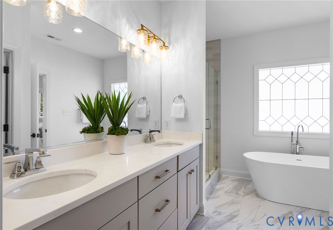 2831 Old Pump Road Henrico, VA 23233 - Photo 28 of 42 a bathroom with a double vanity sink a mirror and a bathtub