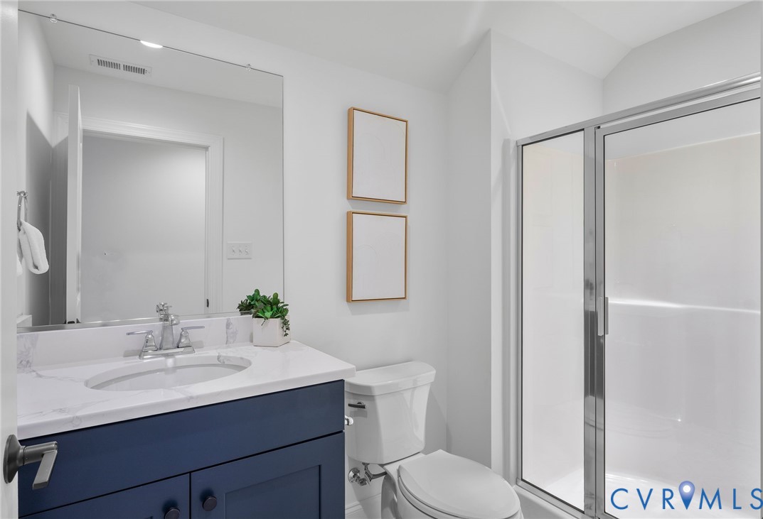 2831 Old Pump Road Henrico, VA 23233 - Photo 37 of 42 a bathroom with a toilet a sink a mirror a vanity and shower