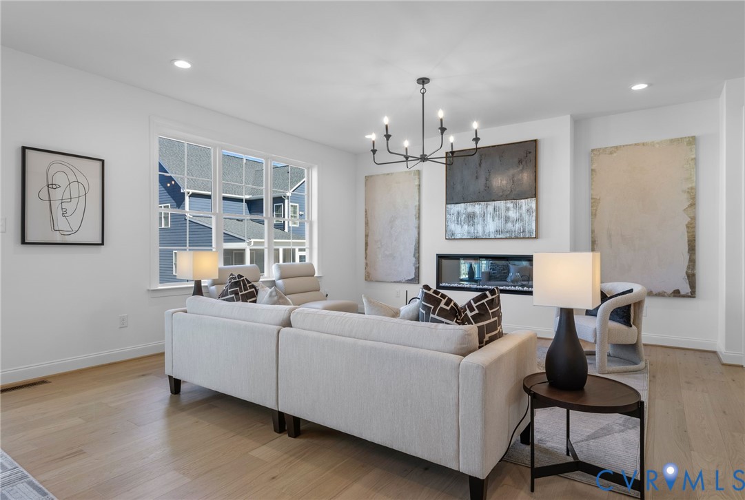2831 Old Pump Road Henrico, VA 23233 - Photo 7 of 42 a living room with furniture and a chandelier