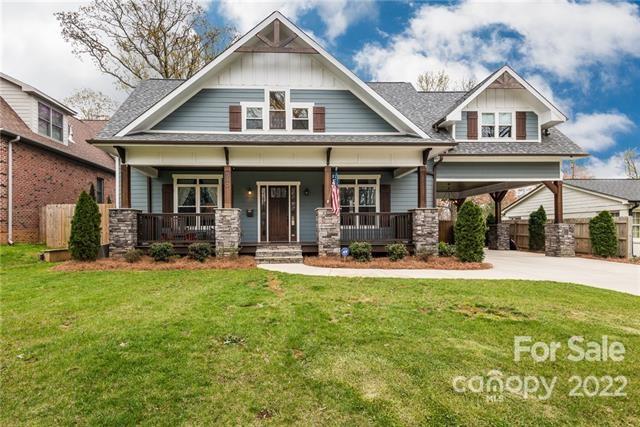 a view of a house with a yard patio and swimming pool