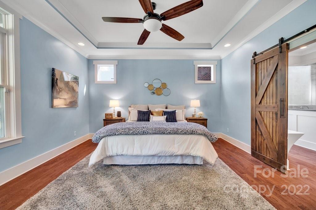 530 McAlway Road Charlotte, NC 28211 - Photo 14 of 36 a spacious bedroom with a bed and a chandelier