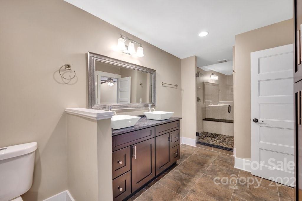 530 McAlway Road Charlotte, NC 28211 - Photo 22 of 36 a bathroom with a granite countertop sink mirror and a toilet