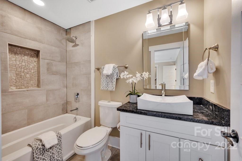 530 McAlway Road Charlotte, NC 28211 - Photo 27 of 36 a bathroom with a granite countertop sink a toilet and shower
