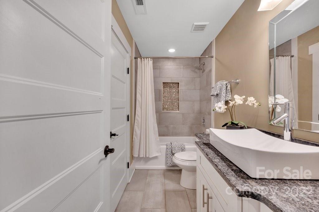 530 McAlway Road Charlotte, NC 28211 - Photo 30 of 36 a bathroom with a granite countertop sink a toilet and shower