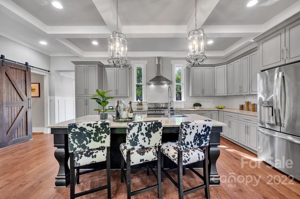 530 McAlway Road Charlotte, NC 28211 - Photo 9 of 36 a view of a dining room with furniture a chandelier and wooden floor