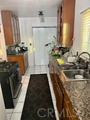 a bathroom with a granite countertop sink a toilet and shower