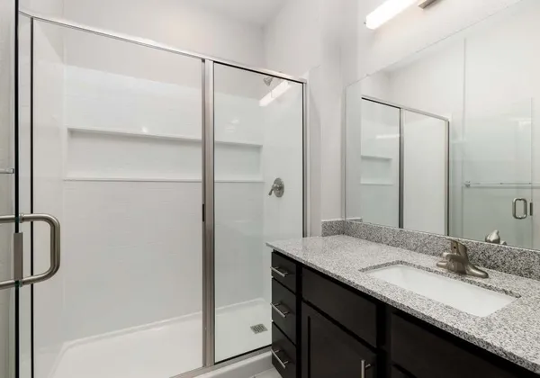 a bathroom with a granite countertop sink mirror and double