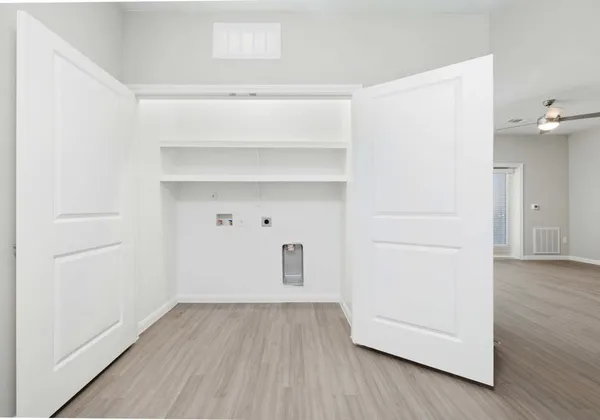 a view of a room with wooden floor