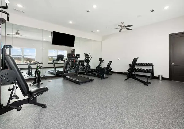 a view of a livingroom with gym equipment