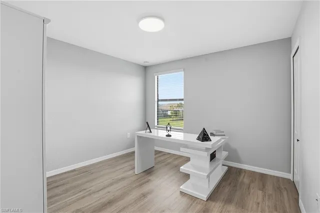 a work room with wooden floor and a window