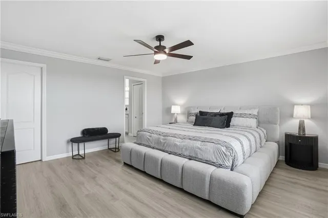 a spacious bedroom with a bed and a chair